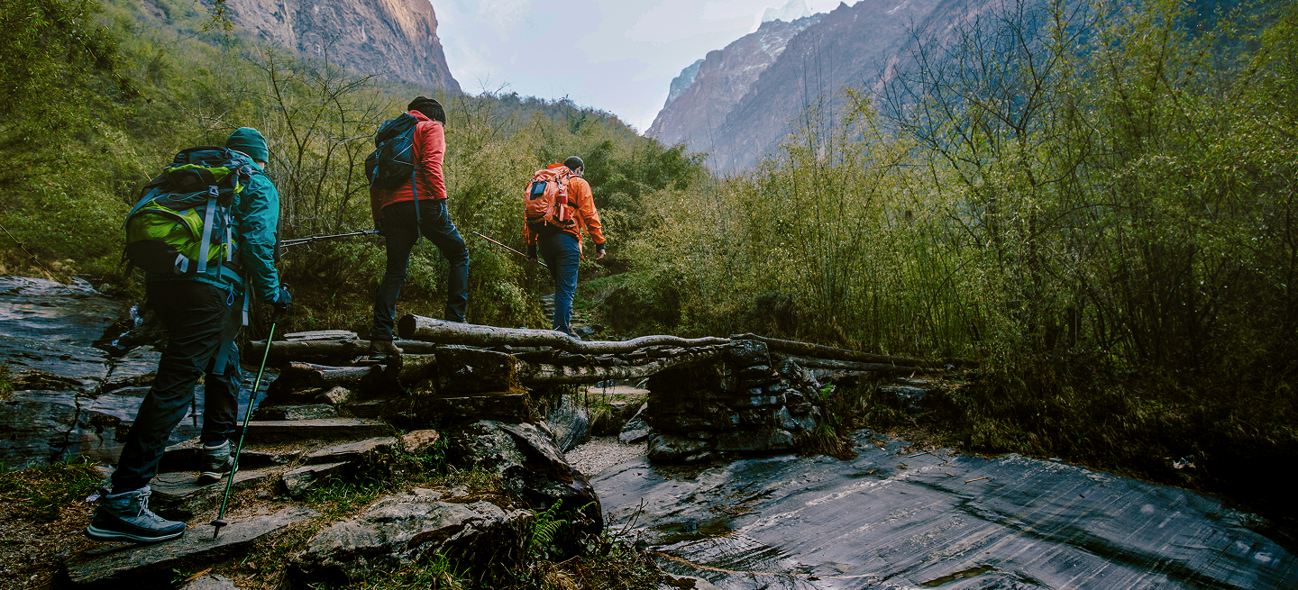 Hikers crossing stream